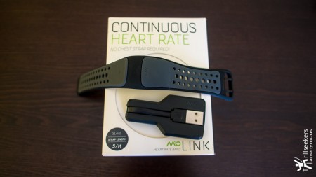 Mio LINK, out of the box, with USB charger, flexible silicone wristband with optical sensor attached