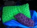 Compressible pillows, uncompressed green (size L) and compressed purple (size XL)