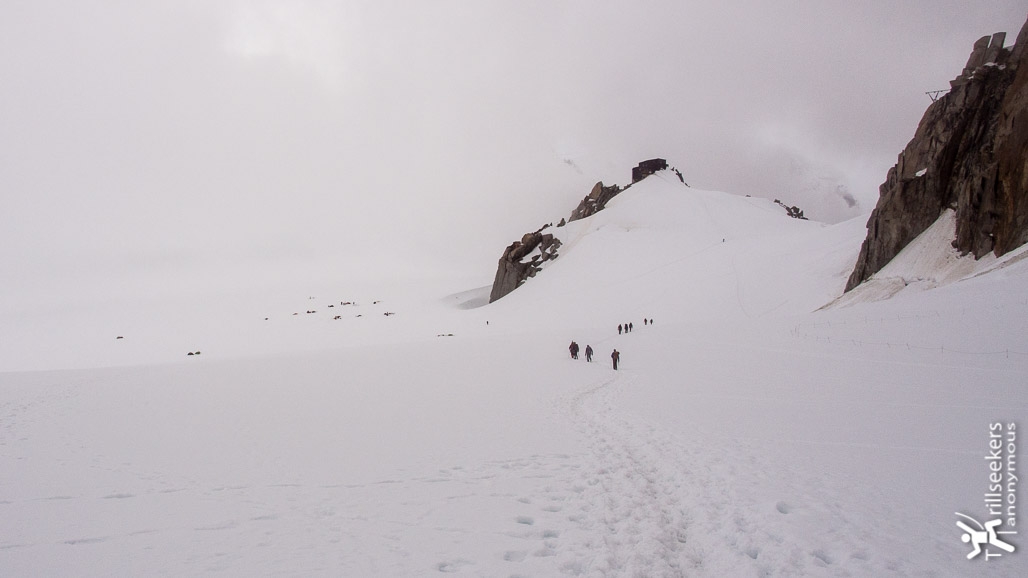 Approaching the Cosmiques Hut (center right) from the Aiguille du Midi with the campers on the glacier (left).